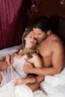 Sexy sensual heterosexual couple, man, young caucasian woman in love on bed kissing, hugging. Beautiful passionate couple is having sex in a bedroom. Portrait of passion, pleasure, sex, relationship. Copulating
